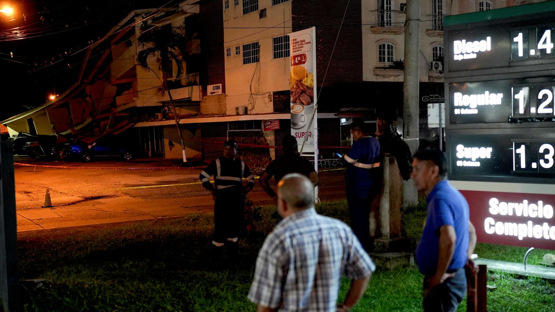 Varias personas permanecen de pie junto a automóviles dañados por la caída de escombros tras un terremoto que sacudió la costa sur de Panamá, en Penonomé, Panamá, el 9 de octubre de 2026  - Sputnik Mundo, 1920, 10.10.2026
