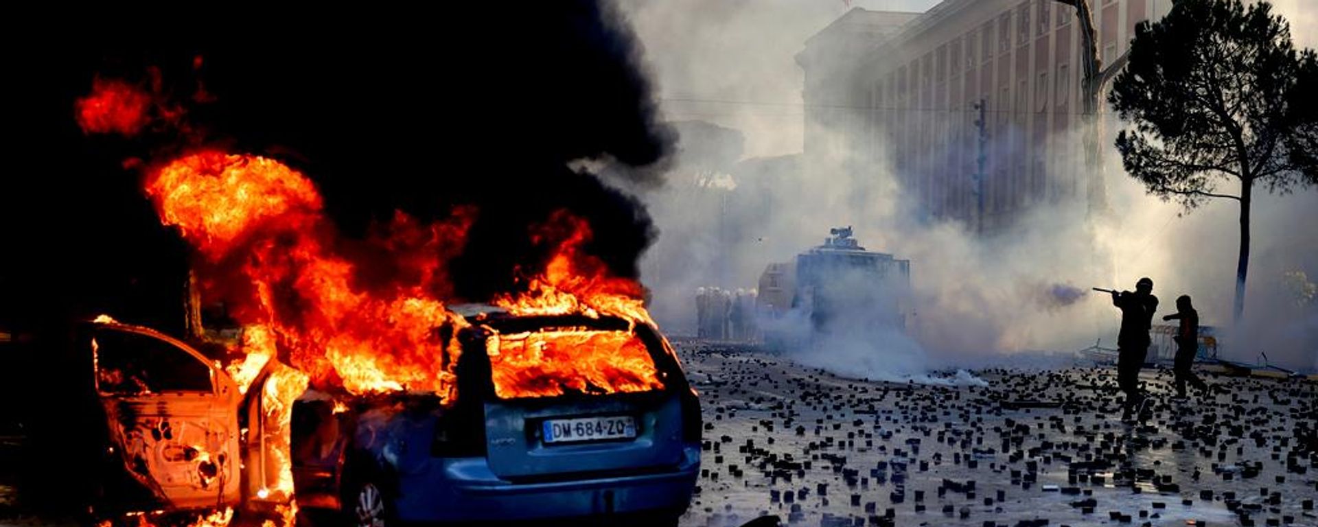 Un vehículo arde en medio de los disturbios de una manifestación antigubernamental ante la oficina del primer ministro en Tirana, Albania - Sputnik Mundo, 1920, 19.10.2026