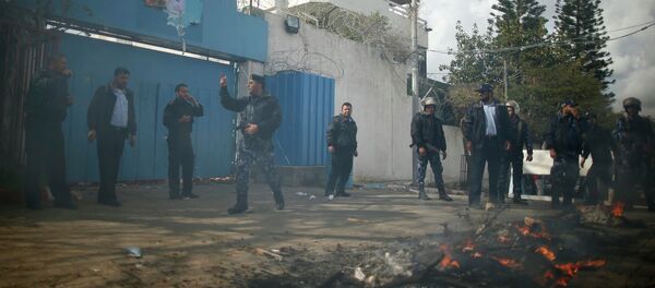 Palestinian policemen loyal to Hamas stand guard after Palestinians attacked the headquarters of the United Nations Special Coordinator during a protest against the decision by the main U.N. aid agency to suspend payments to tens of thousands of Palestinians for repairs to their homes damaged in last summer's war, in Gaza City January 28, 2015 - Sputnik Mundo