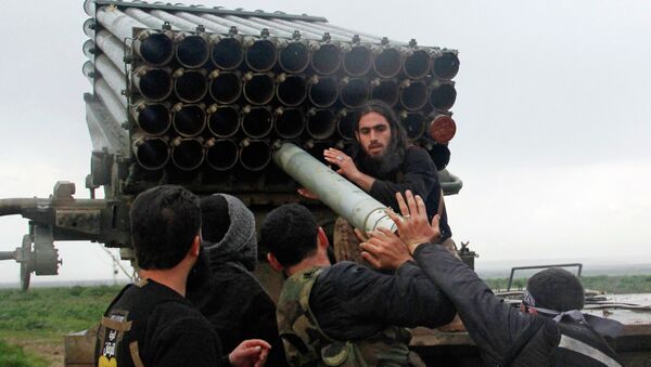 Rebel fighters of the Al-Furqan brigade prepare Grad rockets to be launched towards forces loyal to Syria's President Bashar Al-Assad stationed in Salhab village, from the orchards of the west of al-Zukat village - Sputnik Mundo