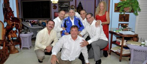 Cuba's former President Fidel Castro (C, in blue jacket) and his wife Dalia Soto Del Valle (R, in red dress) pose for a photograph with the so-called Cuban Five Ramon Labanino (C, front), Fernando Gonzalez (L), Gerardo Hernandez (2nd L), Antonio Guerrero (3rd R) and Rene Gonzalez (2nd R) in this picture provided by Cubadebate - Sputnik Mundo