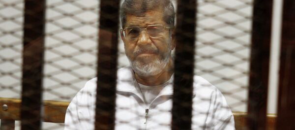 Egypt's ousted Islamist President Mohammed Morsi sits in a defendant cage in the Police Academy courthouse in Cairo, Egypt. On Tuesday April 21, 2015 - Sputnik Mundo