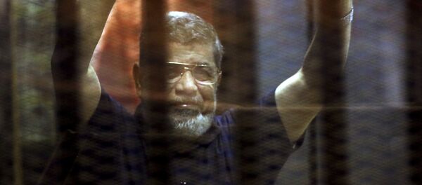 Former Egyptian President Mohamed Mursi reacts behind bars with other Muslim Brotherhood members at a court in the outskirts of Cairo, Egypt May 16, 2015. - Sputnik Mundo
