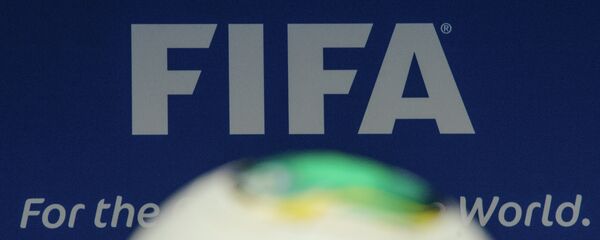 The FIFA logo is pictured behind a ball during the press conference following the meeting of the FIFA executive comittee in Zurich - Sputnik Mundo