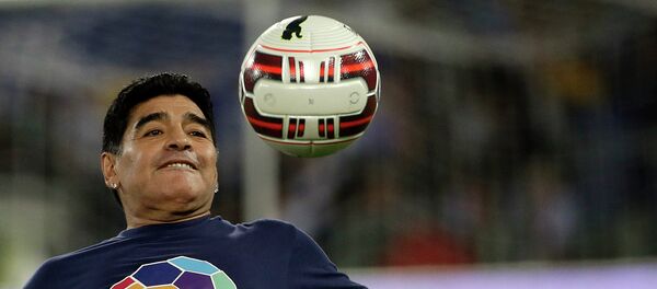 Argentine soccer legend Diego Armando Maradona watches the ball as he warms up prior to the start of an inter-religious match for peace, supported by Pope Francis to promote the dialogue and peace among different religions, at Rome's Olympic Stadium, Monday, Sept. 1, 2014. Argentine soccer legend Diego Armando Maradona watches the ball as he warms up prior to the start of an inter-religious match for peace, supported by Pope Francis to promote the dialogue and peace among different religions, at Rome's Olympic Stadium, Monday, Sept. 1, 2014. - Sputnik Mundo
