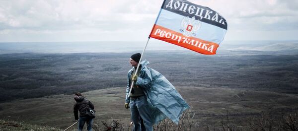 Hombre con la bandera de autoproclamada República Popular de Donetsk - Sputnik Mundo