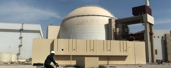 In this Oct. 26, 2010 file photo, a worker rides a bicycle in front of the reactor building of the Bushehr nuclear power plant, just outside the southern city of Bushehr. - Sputnik Mundo