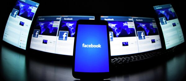 The loading screen of the Facebook application on a mobile phone is seen in this photo illustration taken in Lavigny May 16, 2012. - Sputnik Mundo