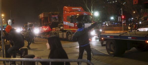 Activista de la comunidad mapuche lanza una piedra a un camión en Santiago - Sputnik Mundo