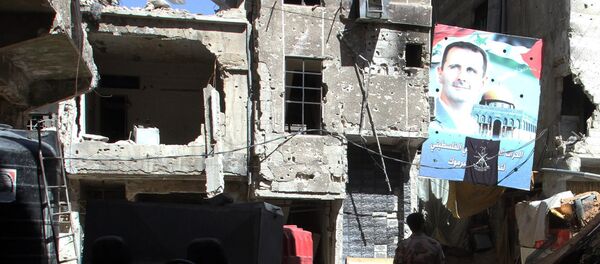 Un retrato del presidente sirio Bashar al-Assad en una calle de la capital siria, Damasco, el 6 de abril de 2015 Un retrato del presidente sirio Bashar al-Assad en una calle de la capital siria, Damasco, el 6 de abril de 2015 - Sputnik Mundo