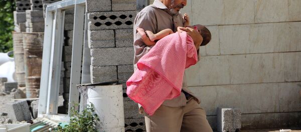 Un hombre lleva a su hija herida al hospital en la ciudad yemení de Taiz - Sputnik Mundo