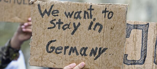 Los refugiados con cartelas que dicen: 'Queremos quedarnos en Alemania' - Sputnik Mundo