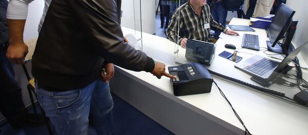 La toma de una huella dactilar en un centro de refugiados en Alemania - Sputnik Mundo