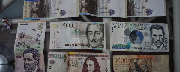 El peso, la moneda de Colombia El peso, la moneda de Colombia - Sputnik Mundo