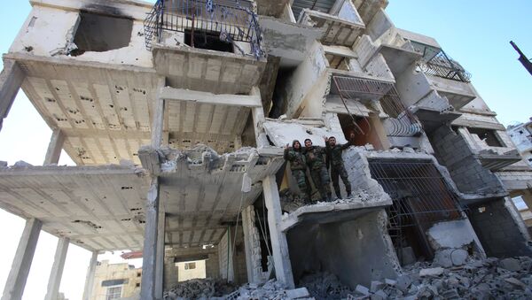 Members of the Syrian pro-government forces pose for a picture in a destroyed building in the strategic town of Salma, in the coastal Latakia province, on January 15, 2016, following its recapture from rebel fighters - Sputnik Mundo