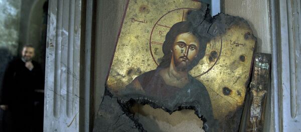 La imagen de Cristo quemada en una iglesia en Siria La imagen de Cristo quemada en una iglesia en Siria - Sputnik Mundo