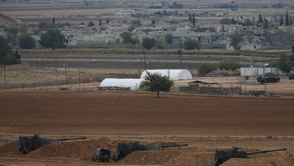 Turkish soldiers hold their positions with their artillery pieces, bottom, on a hilltop in the outskirts of Suruc, at the Turkey-Syria border, overlooking Kobani, Syria, background, during fighting between Syrian Kurds and the militants of Islamic State group, Thursday, Oct. 16, 2014 - Sputnik Mundo