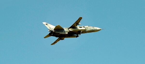 Su-24 tactical bomber of the Russian air forces over the Hmeimim air base in the Lattakia province - Sputnik Mundo