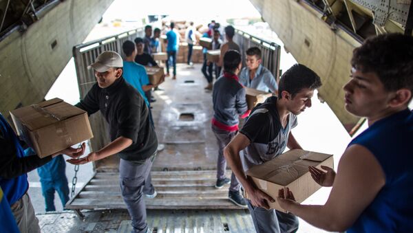 Unloading Russian EMERCOM plane with humanitarian aid which arrived to Latakia Airport in Syria. File photo - Sputnik Mundo