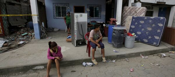 Ecuatorianos en frente de la casa en ruinas - Sputnik Mundo