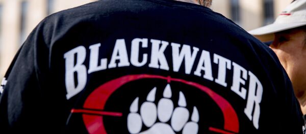 A former member of Blackwater joines family members, friends, and supporters of four former Blackwater security guards outside the federal court in Washington, Monday, April 13, 2015 - Sputnik Mundo