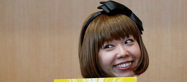 Japanese artist Megumi Igarashi, known as Rokudenashiko, holds her artwork after a news conference following a court appearance in Tokyo - Sputnik Mundo