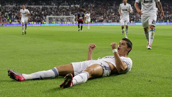 Real Madrid's Cristiano Ronaldo from Portugal celebrates after scoring against Racing Santander during a Spanish La Liga soccer match at the Santiago Bernabeu stadium in Madrid - Sputnik Mundo