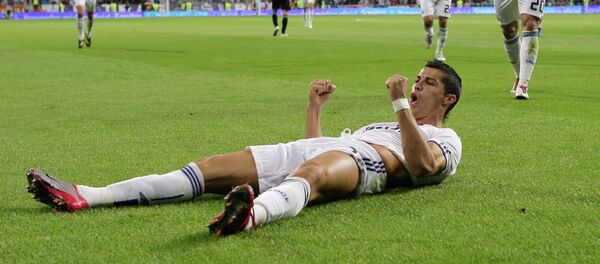Real Madrid's Cristiano Ronaldo from Portugal celebrates after scoring against Racing Santander during a Spanish La Liga soccer match at the Santiago Bernabeu stadium in Madrid - Sputnik Mundo
