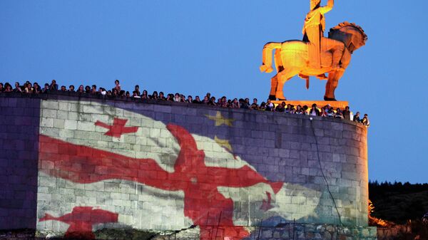 Georgian national and EU flags projected on the wall of the Metekhi Church with a monument to Vakhtang I Gorgasali, a king of Iberia, right, during a concert marking the signing of the association with EU agreement in Tbilisi, Georgia, Friday, June 27, 2014 - Sputnik Mundo