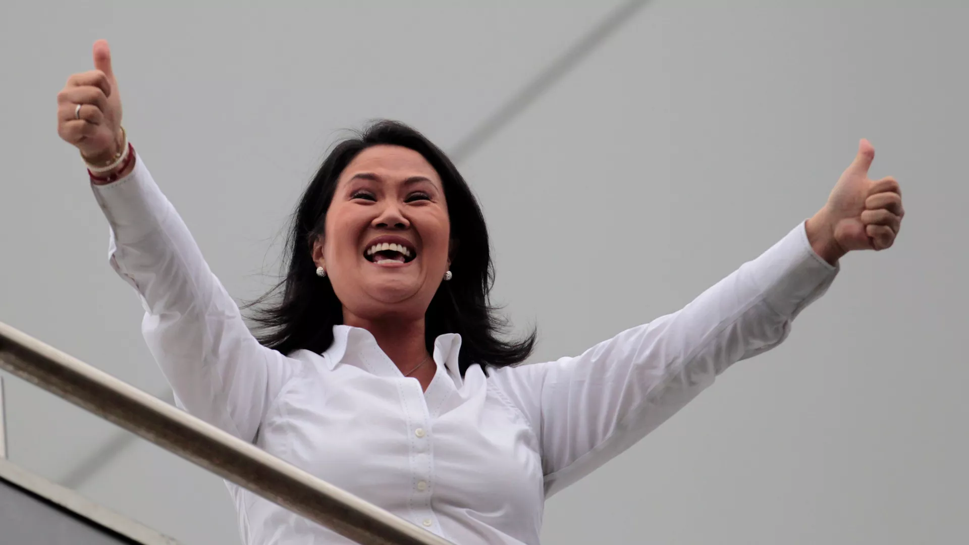 Peruvian presidential candidate Keiko Fujimori gestures towards followers from a building in Lima, Peru