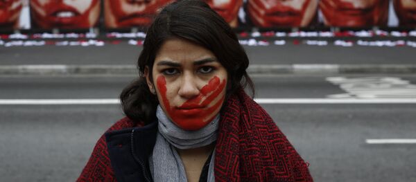 A member of the NGO Rio de Paz poses during an exhibit demonstration against violence against women, displaying some 420 panties and portraits of bloodstained women, in Paulista Avenue in Sao Paulo, Brazil on June 10, 2016. - Sputnik Mundo