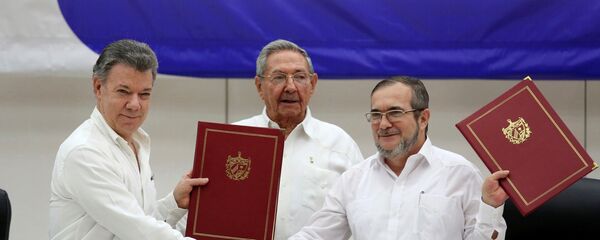 Cuba's President Raul Castro, Colombia's President Juan Manuel Santos and FARC rebel leader Rodrigo Londono react after signing a historic ceasefire deal between the Colombian government and FARC rebels in Havana - Sputnik Mundo