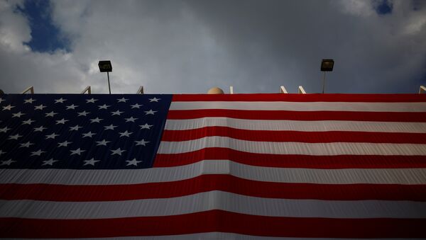 An American flag hangs opposite the Quicken Loans Arena as setup continues in advance of the Republican National Convention in Cleveland, Ohio - Sputnik Mundo