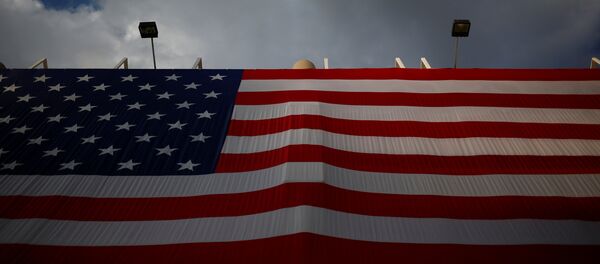 An American flag hangs opposite the Quicken Loans Arena as setup continues in advance of the Republican National Convention in Cleveland, Ohio - Sputnik Mundo