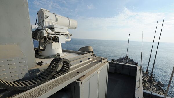 In this November 16, 2014 US Navy handout image the Afloat Forward Staging Base (Interim) USS Ponce (ASB(I) 15) conducts an operational demonstration of the Office of Naval Research (ONR)-sponsored Laser Weapon System (LaWS) while deployed to the Gulf. - Sputnik Mundo