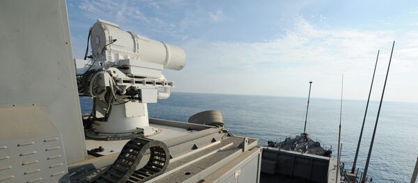In this November 16, 2014 US Navy handout image the Afloat Forward Staging Base (Interim) USS Ponce (ASB(I) 15) conducts an operational demonstration of the Office of Naval Research (ONR)-sponsored Laser Weapon System (LaWS) while deployed to the Gulf. - Sputnik Mundo