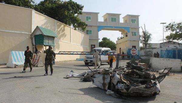 Somali soldiers walk past the wreckage of a car bomb by the main gate outside the presidential palace in Mogadishu (File) Somali soldiers walk past the wreckage of a car bomb by the main gate outside the presidential palace in Mogadishu (File) - Sputnik Mundo