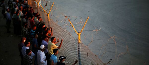 Palestinos en la frontera egipcia de Rafah - Sputnik Mundo