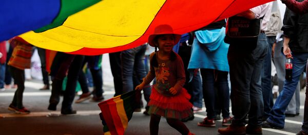 A child runs under a rainbow flag during a march in support of gay marriage, sexual and gender diversity in Mexico City, Mexico - Sputnik Mundo