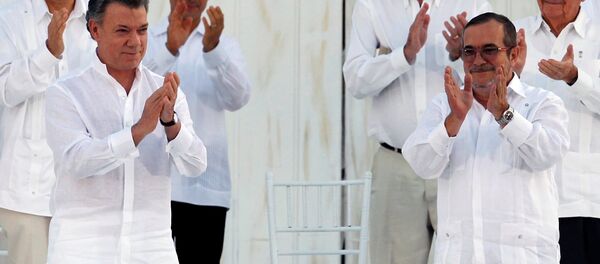 El presidente colombiano, Juan Manuel Santos, y el líder de las FARC, Rodrigo Londoño alias Timochenko  durante la firma del Acuerdo Final sobre la Paz en Cartagena, el 26 de septiembre de 2016 - Sputnik Mundo