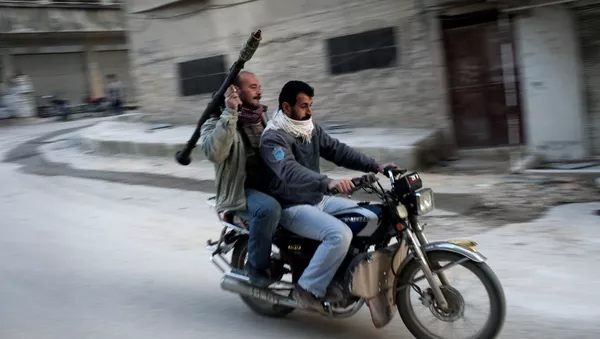 Supporters of the Free Syrian Army ride a motorcycle with a rocket-propelled grenade in Kafar Taharim, Syria. - Sputnik Mundo