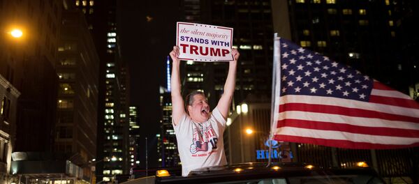 A supporter of U.S. Republican presidential candidate Donald Trump cheers near the intersection of West 54th Street and Fifth Avenue in New York, U.S. - Sputnik Mundo