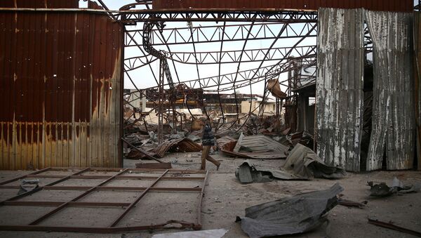 A man walks past the damage at a site hit yesterday by airstrikes in the rebel held besieged Douma neighbourhood of Damascus, Syria - Sputnik Mundo