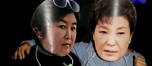 Manifestantes surcoreanos con las fotos de Park Geun-hye, presidenta del país, y su amiga Choi Soon-sil (archivo) - Sputnik Mundo