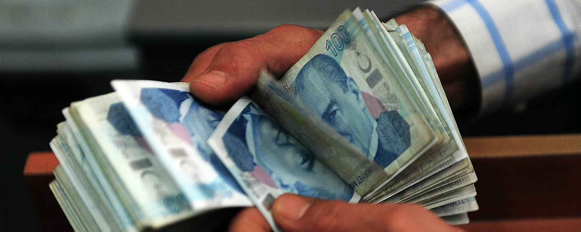 An exchange office worker counts Turkish lira banknotes in Istanbul on June 8, 2015 An exchange office worker counts Turkish lira banknotes in Istanbul on June 8, 2015 - Sputnik Mundo, 1920, 24.08.2022