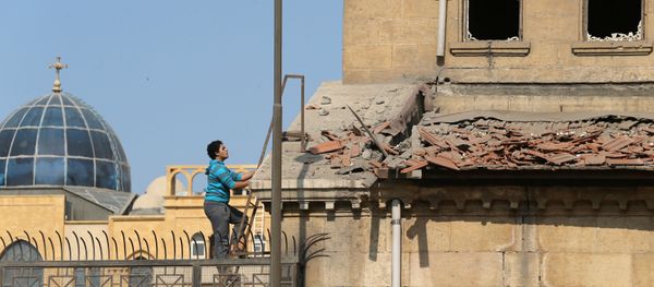 A Christian employee at Cairo’s Coptic Cathedral checks for damage from the blast after an explosion inside the cathedral in Cairo A Christian employee at Cairo’s Coptic Cathedral checks for damage from the blast after an explosion inside the cathedral in Cairo - Sputnik Mundo
