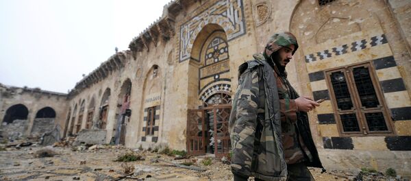 A member of forces loyal to Syria's President Bashar al-Assad walks inside the Umayyad mosque, in the government-controlled area of Aleppo, during a media tour, Syria - Sputnik Mundo