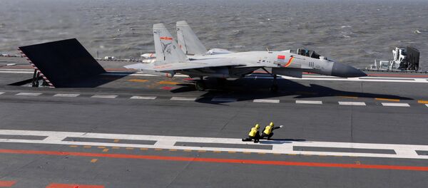 This picture taken on an undisclosed date in December 2016 shows a Chinese J-15 fighter jet preparing to take off from the deck of the Liaoning aircraft carrier - Sputnik Mundo