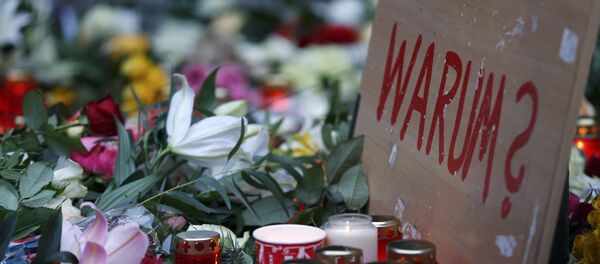 A placard reading Why? is placed at the Christmas market in Berlin A placard reading Why? is placed at the Christmas market in Berlin - Sputnik Mundo