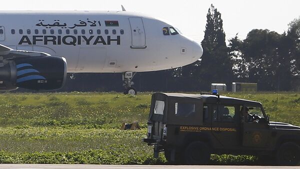 A Maltese military vehicle stands near a hijacked Libyan Afriqiyah Airways Airbus A320 on the runway at Malta Airport - Sputnik Mundo